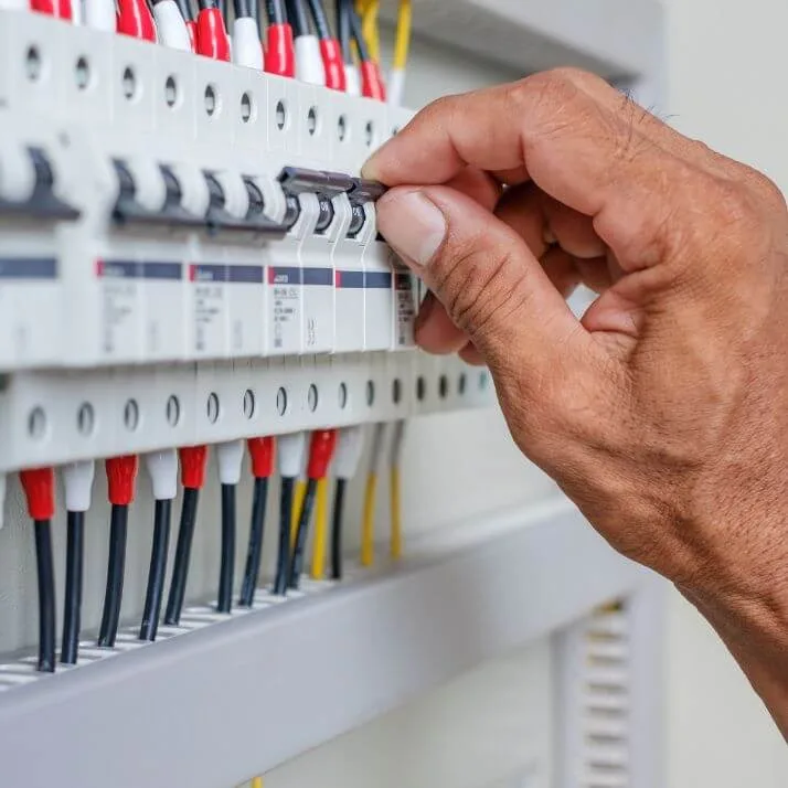 Hand resetting a breaker on a distribution board